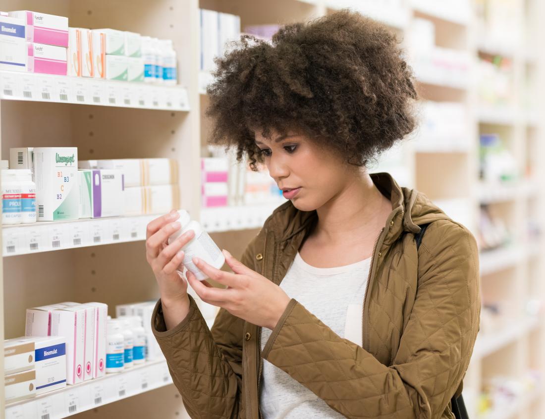 a young woman checking out spermidine supplement